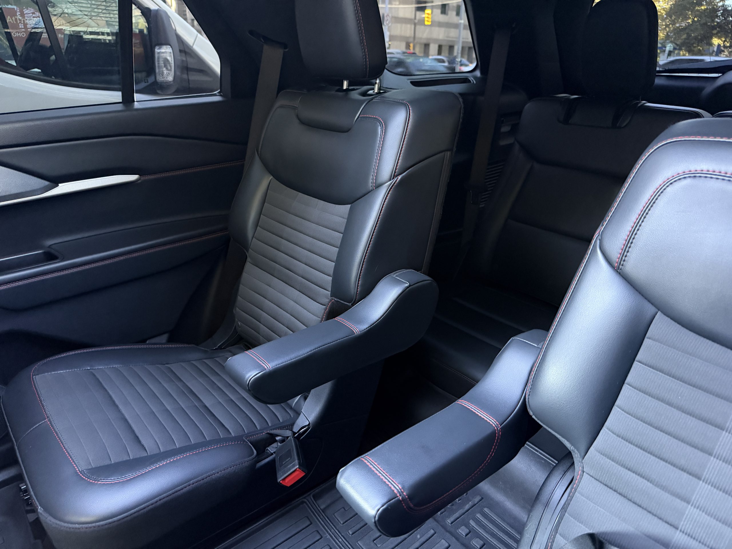 The Explorer’s second-row captain’s chairs, cloth inserts and red stitching.