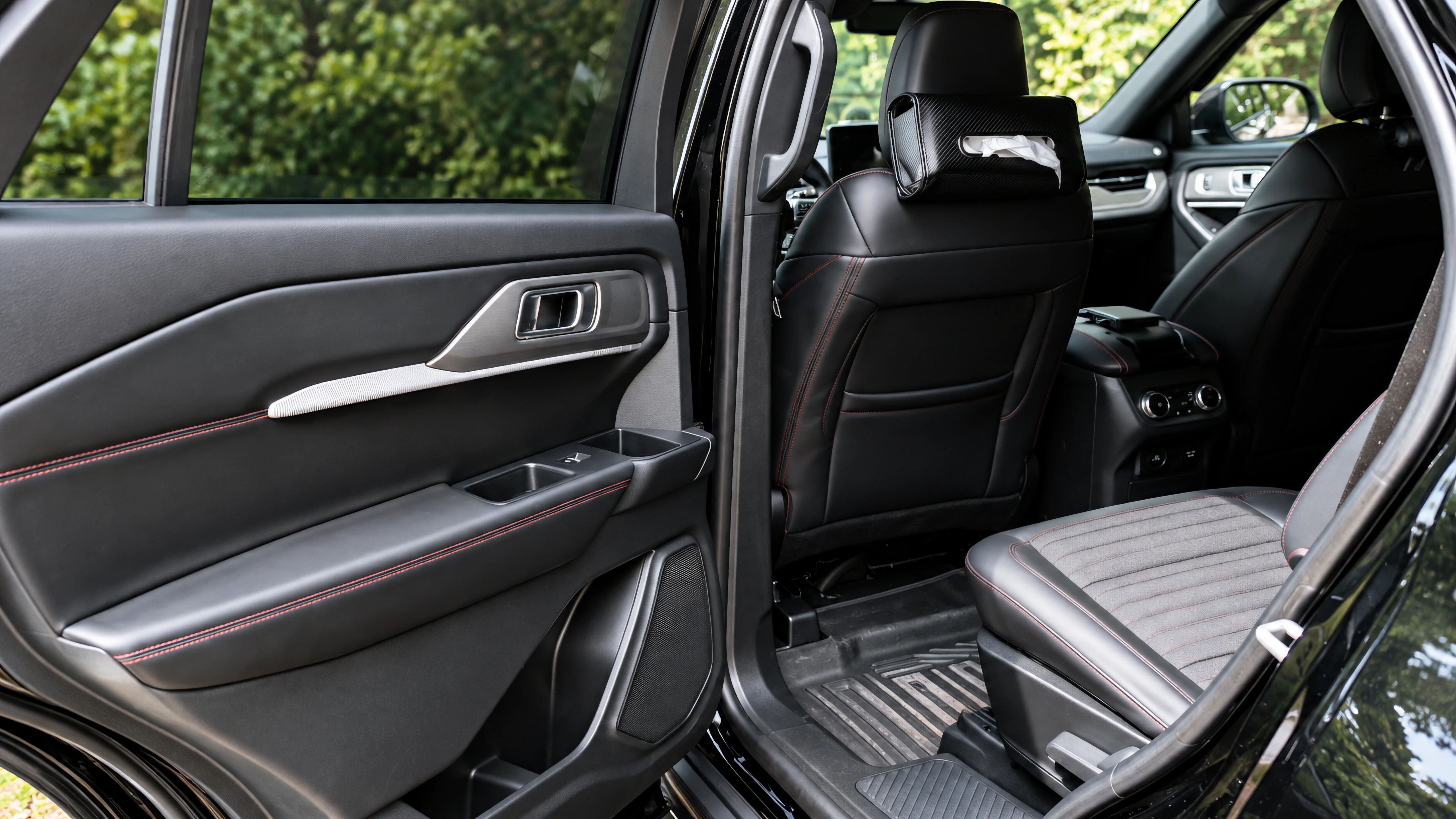 Doorway, grab handle, floor mat and rear climate controls. Edited from an owner photo.